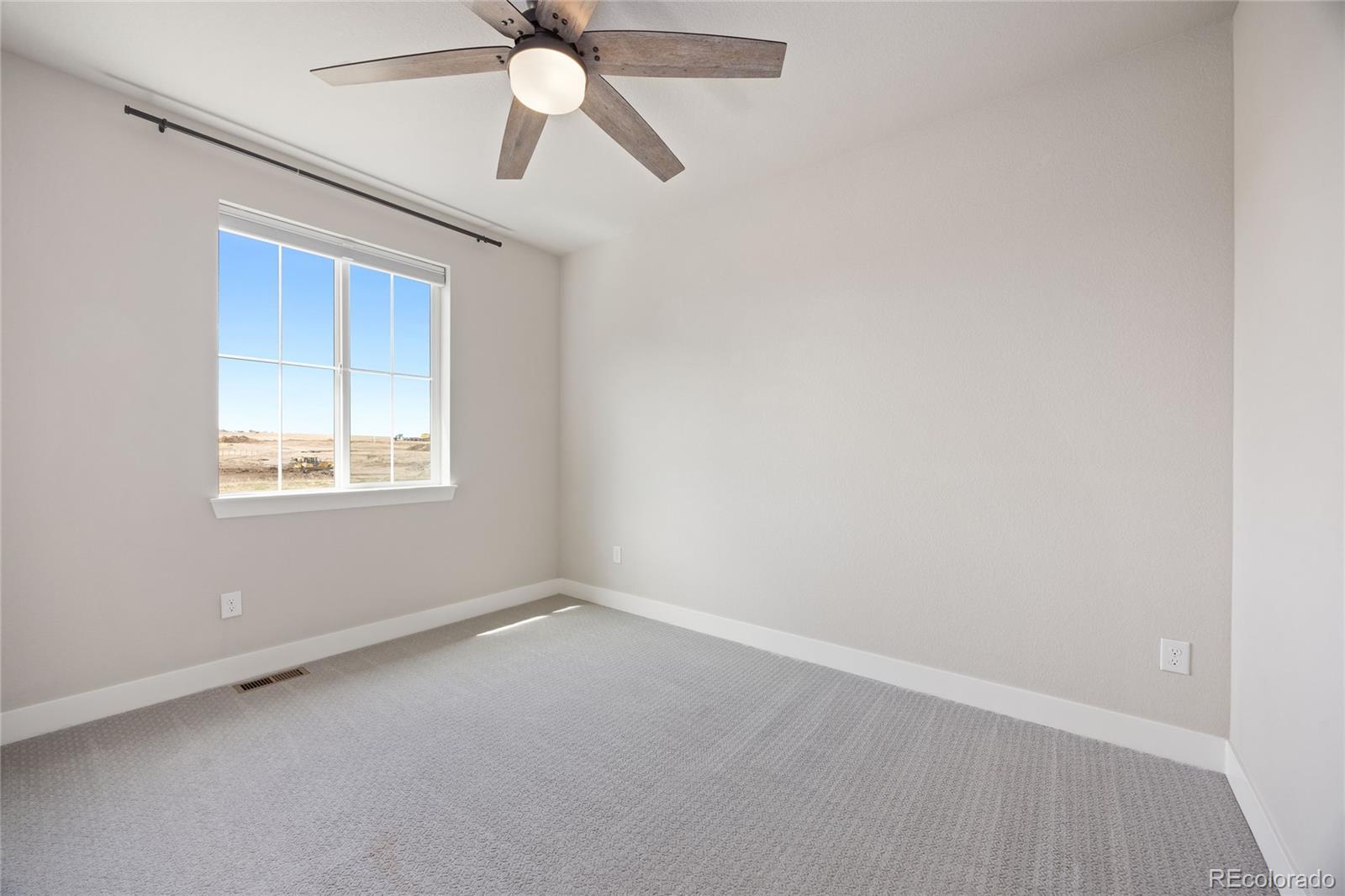 12649 Buffington Trail Parker, CO 80134 - Photo 30 of 47 an empty room with a window and a fan