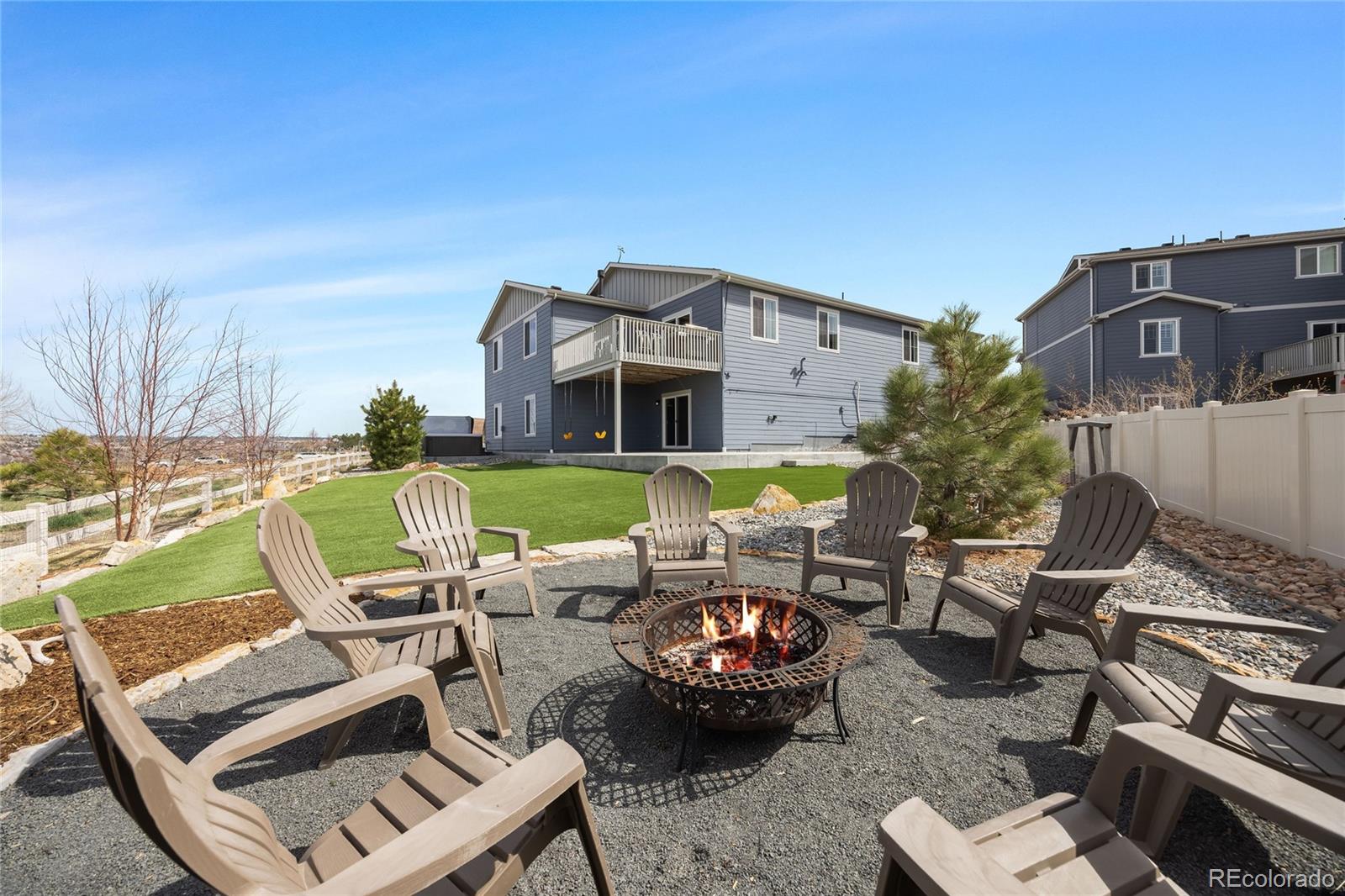 12649 Buffington Trail Parker, CO 80134 - Photo 36 of 47 a view of a patio with couches table and chairs with wooden floor and fence