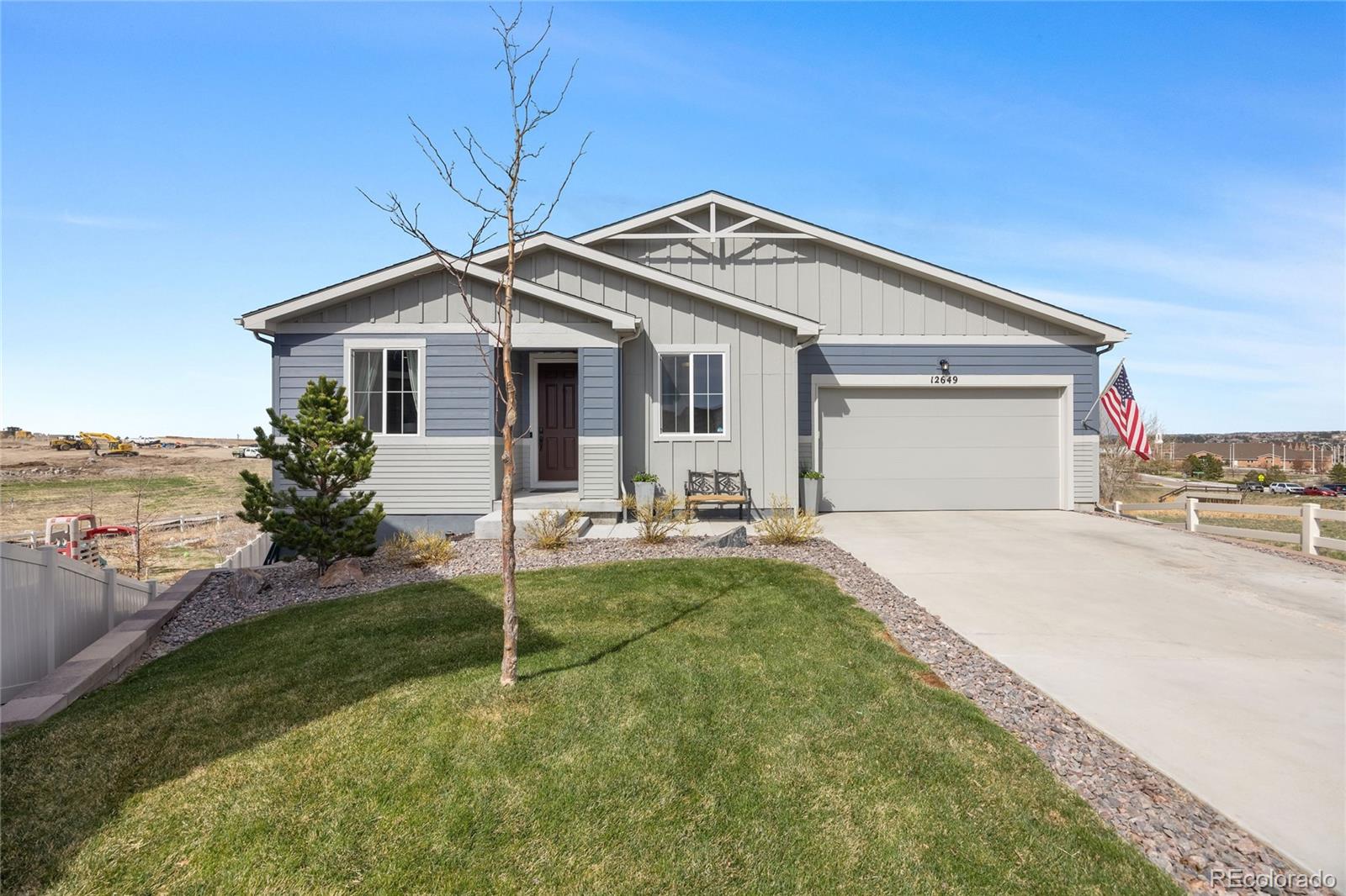 12649 Buffington Trail Parker, CO 80134 - Photo 38 of 47 a front view of a house with a garden and yard