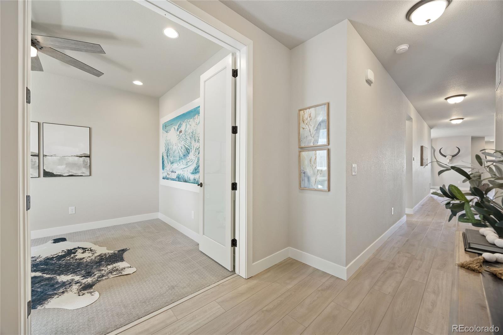 12649 Buffington Trail Parker, CO 80134 - Photo 5 of 47 a view of a hallway with wooden floor and closet