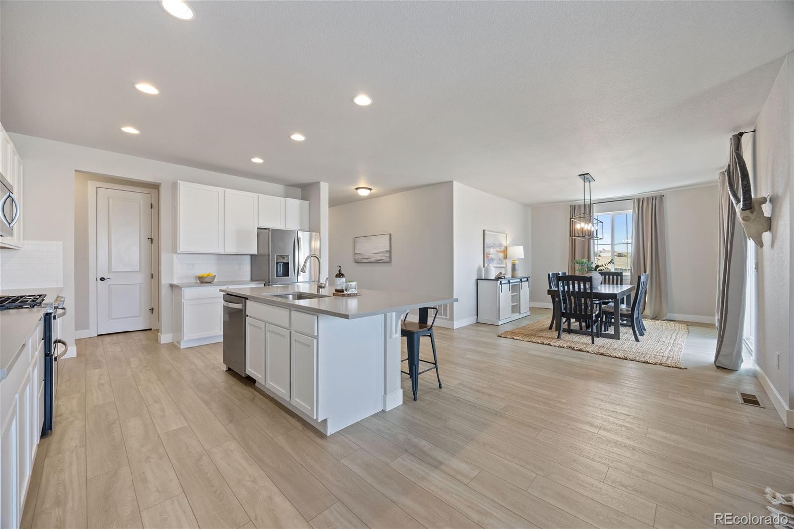 12649 Buffington Trail Parker, CO 80134 - Photo 10 of 47 a kitchen with a sink cabinets and wooden floor