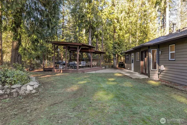 a backyard of a house with yard and outdoor seating