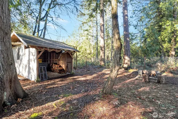 a view of a house with a yard and sitting area