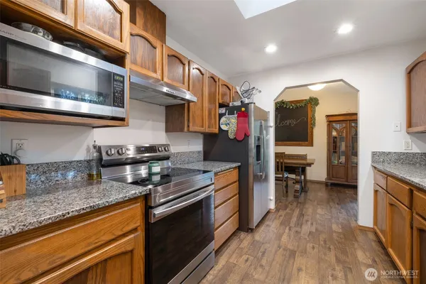 a kitchen with stainless steel appliances granite countertop a stove and a sink