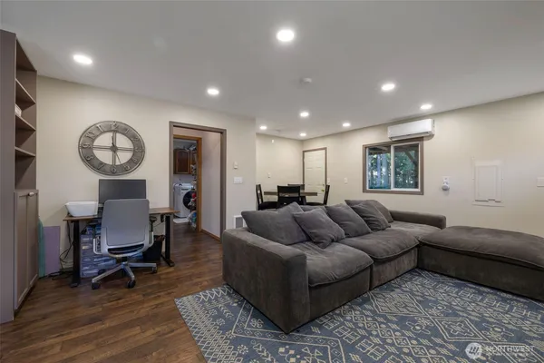 a living room with furniture and a mirror