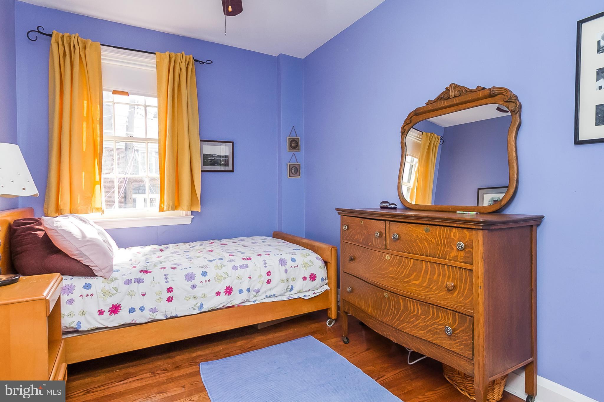 7051 Heathfield Road Baltimore, MD 21212 - Photo 11 of 17 a bedroom with a bed and wooden floor