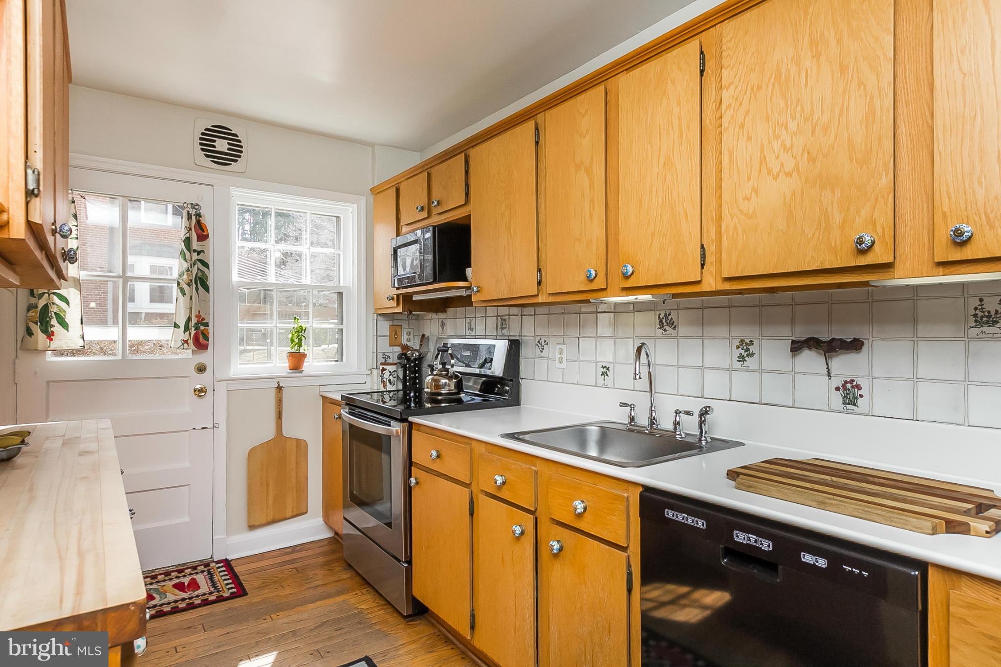 7051 Heathfield Road Baltimore, MD 21212 - Photo 7 of 17 a kitchen with stainless steel appliances granite countertop a stove a sink and a microwave