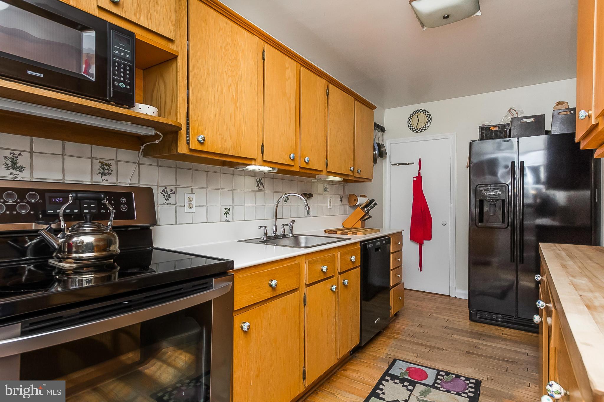 7051 Heathfield Road Baltimore, MD 21212 - Photo 8 of 17 a kitchen with stainless steel appliances granite countertop a stove and a sink