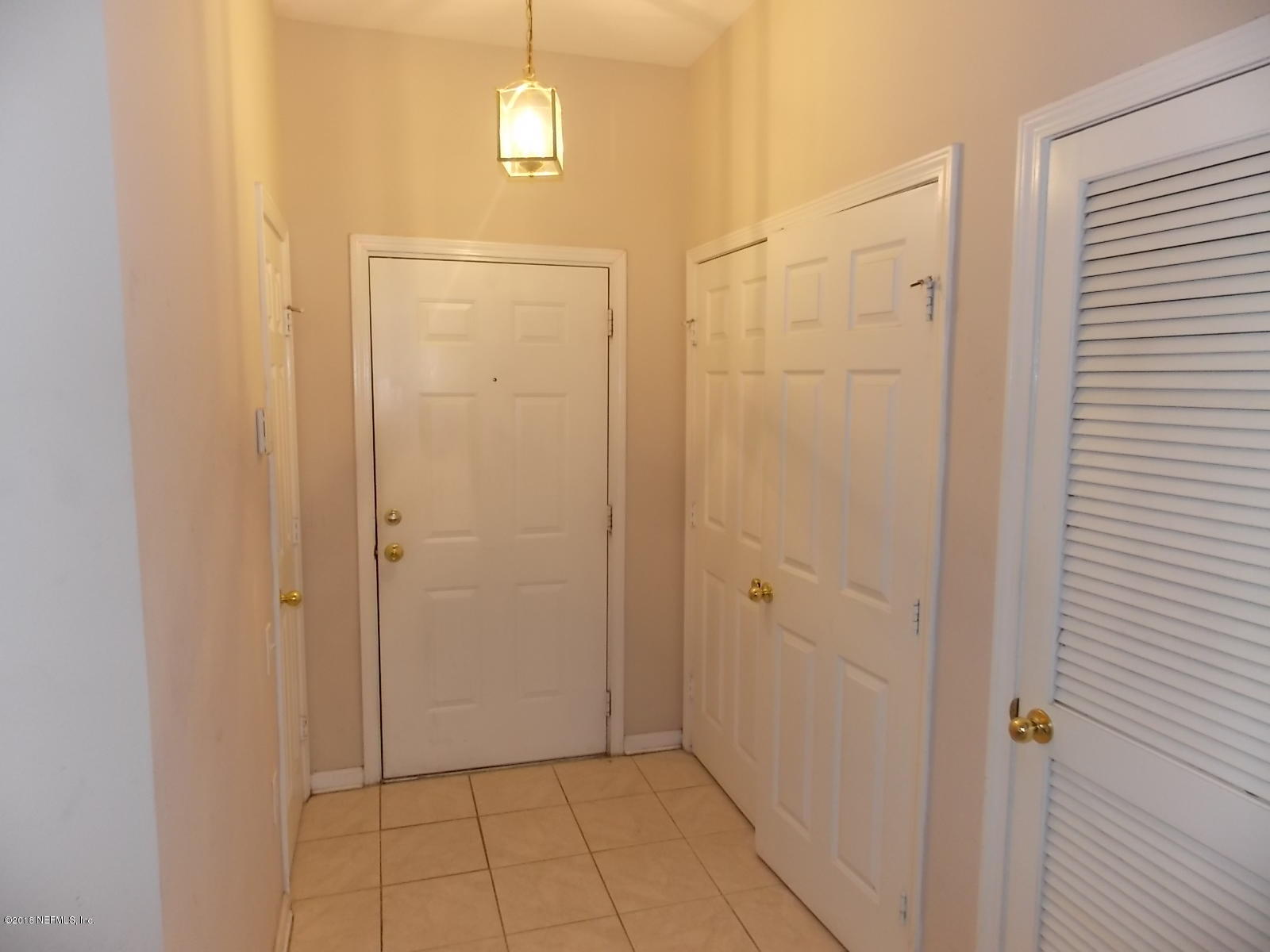 10550 Baymeadows Road, Unit 125 Jacksonville, FL 32256 - Photo 3 of 22 Foyer with Laundry on Right