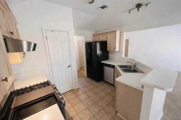 a kitchen with a stove and a refrigerator