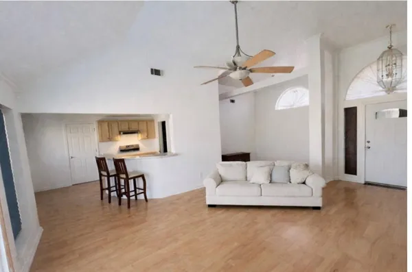 a living room with furniture and white walls