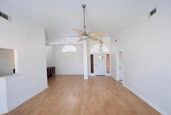 a view of a room with a ceiling fan and a window