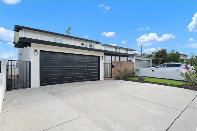 a view of a house with a yard and garage