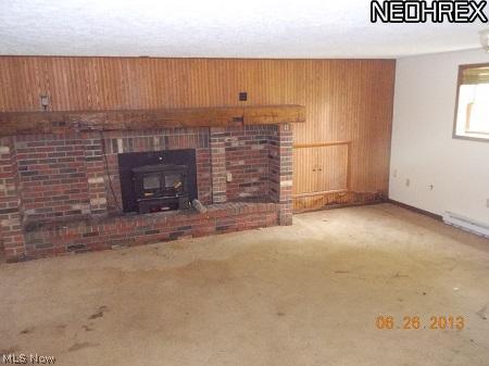 1742 Doyle Road Jefferson, OH 44047 - Photo 4 of 13 livingroom on lower level features a fireplace and access to the back yard