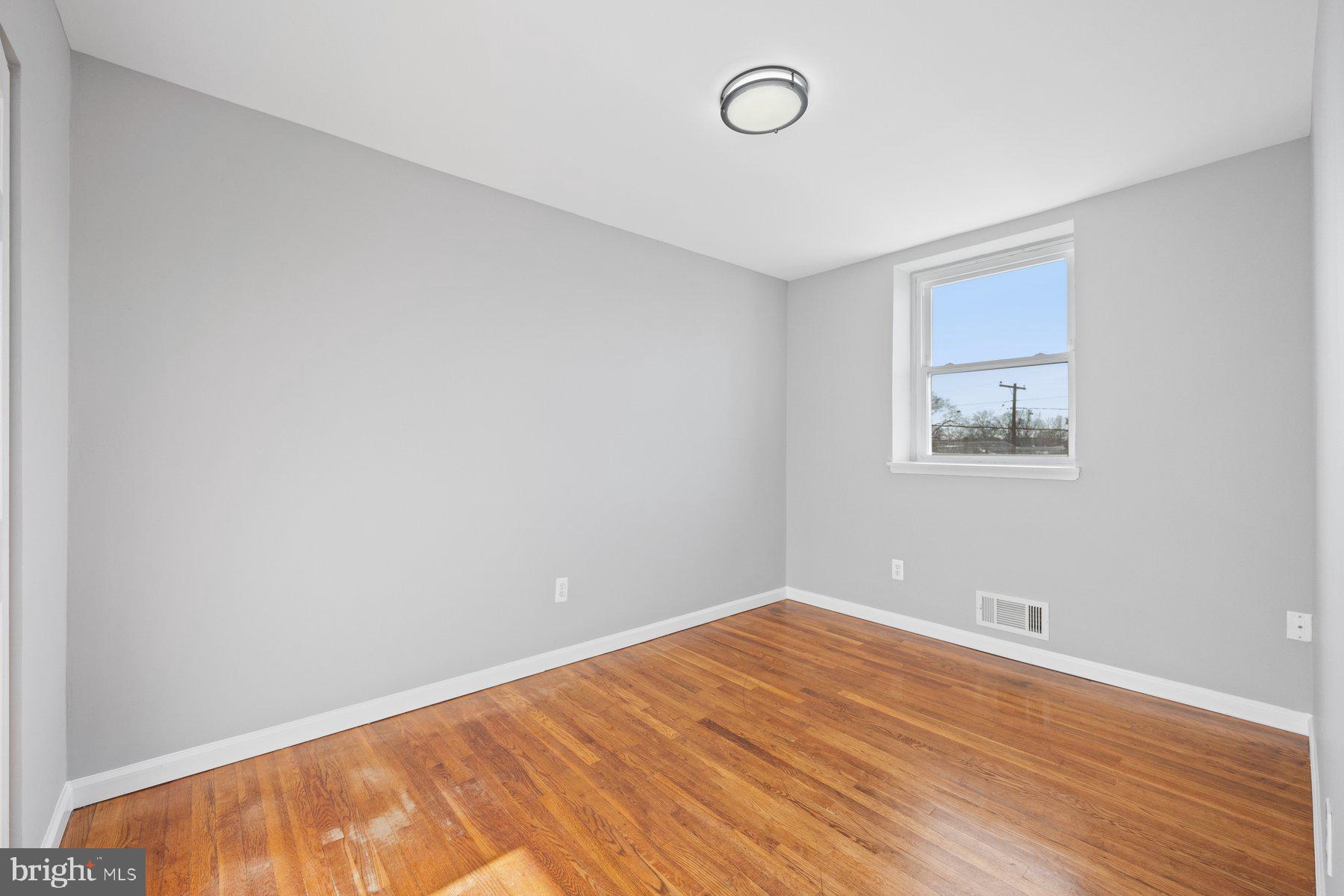 8059 Stratman Road Baltimore, MD 21222 - Photo 20 of 31 a view of an empty room with wooden floor