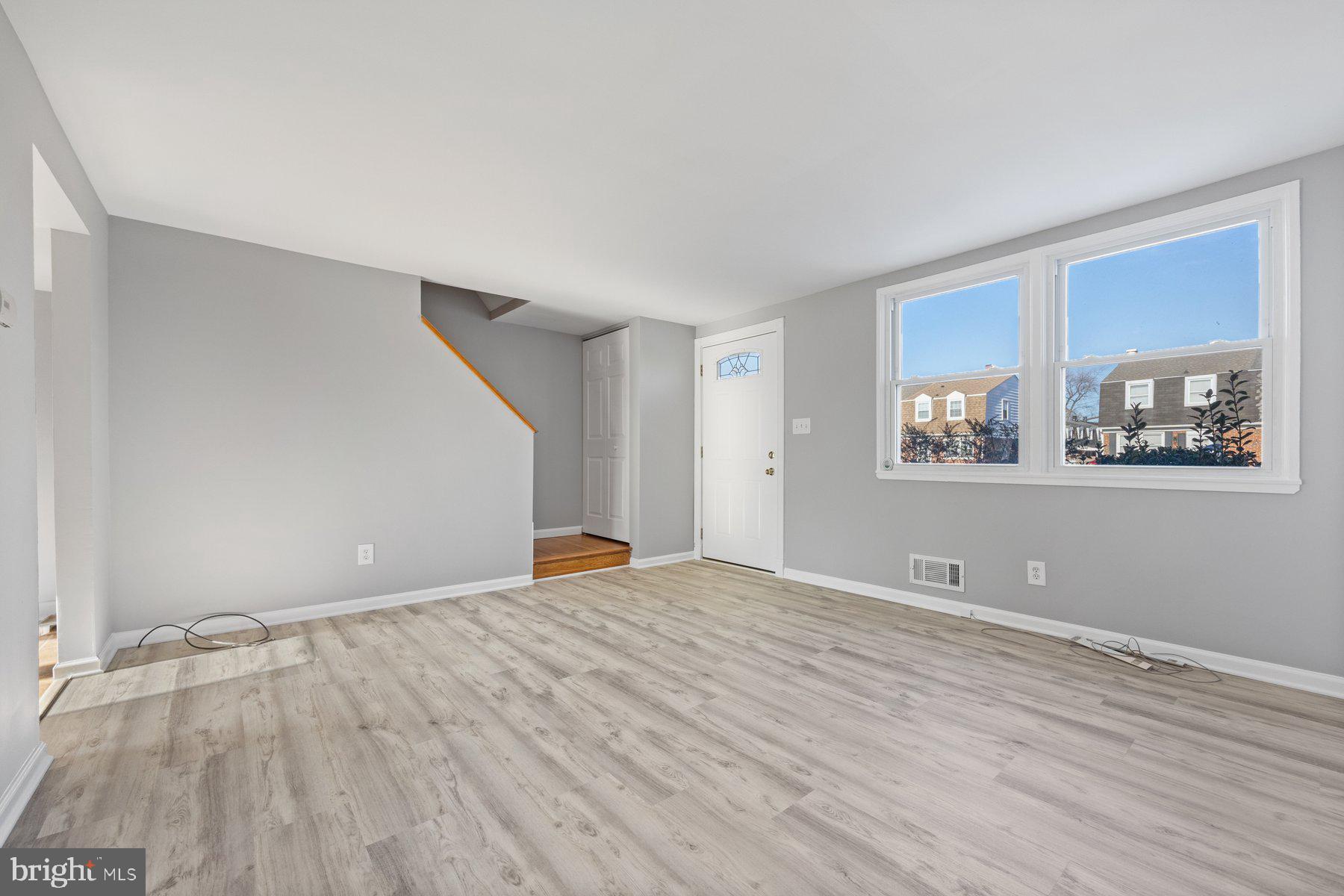 8059 Stratman Road Baltimore, MD 21222 - Photo 7 of 31 a view of empty room with wooden floor and fan