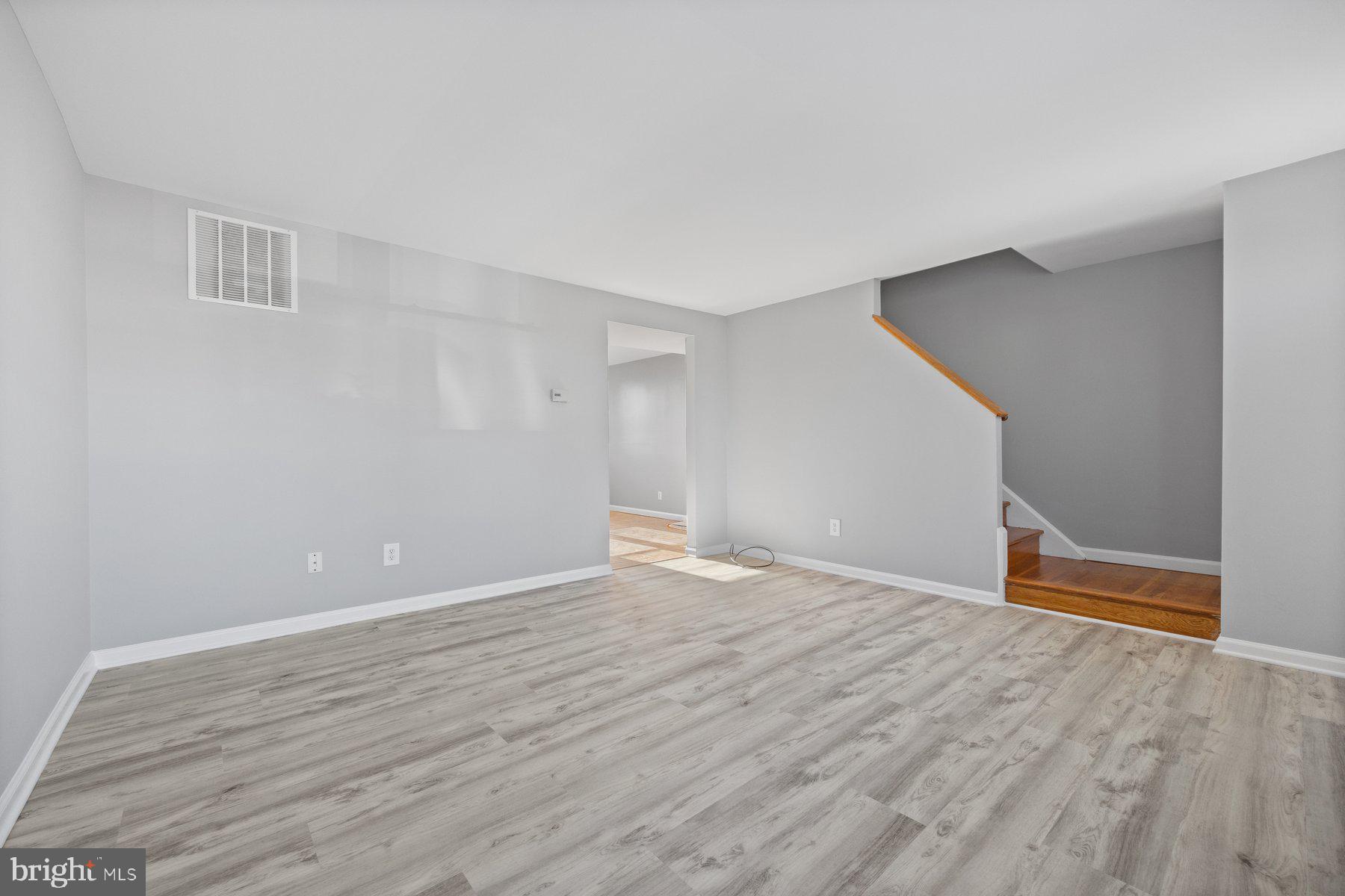 8059 Stratman Road Baltimore, MD 21222 - Photo 8 of 31 a view of an empty room with wooden floor