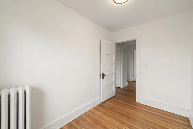 a view of hallway with wooden floor