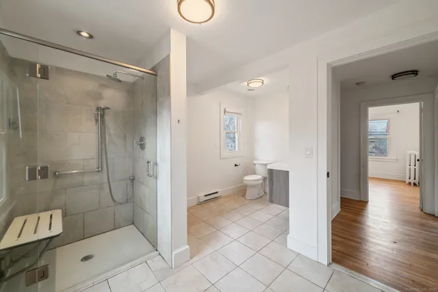 a bathroom with a shower and a toilet