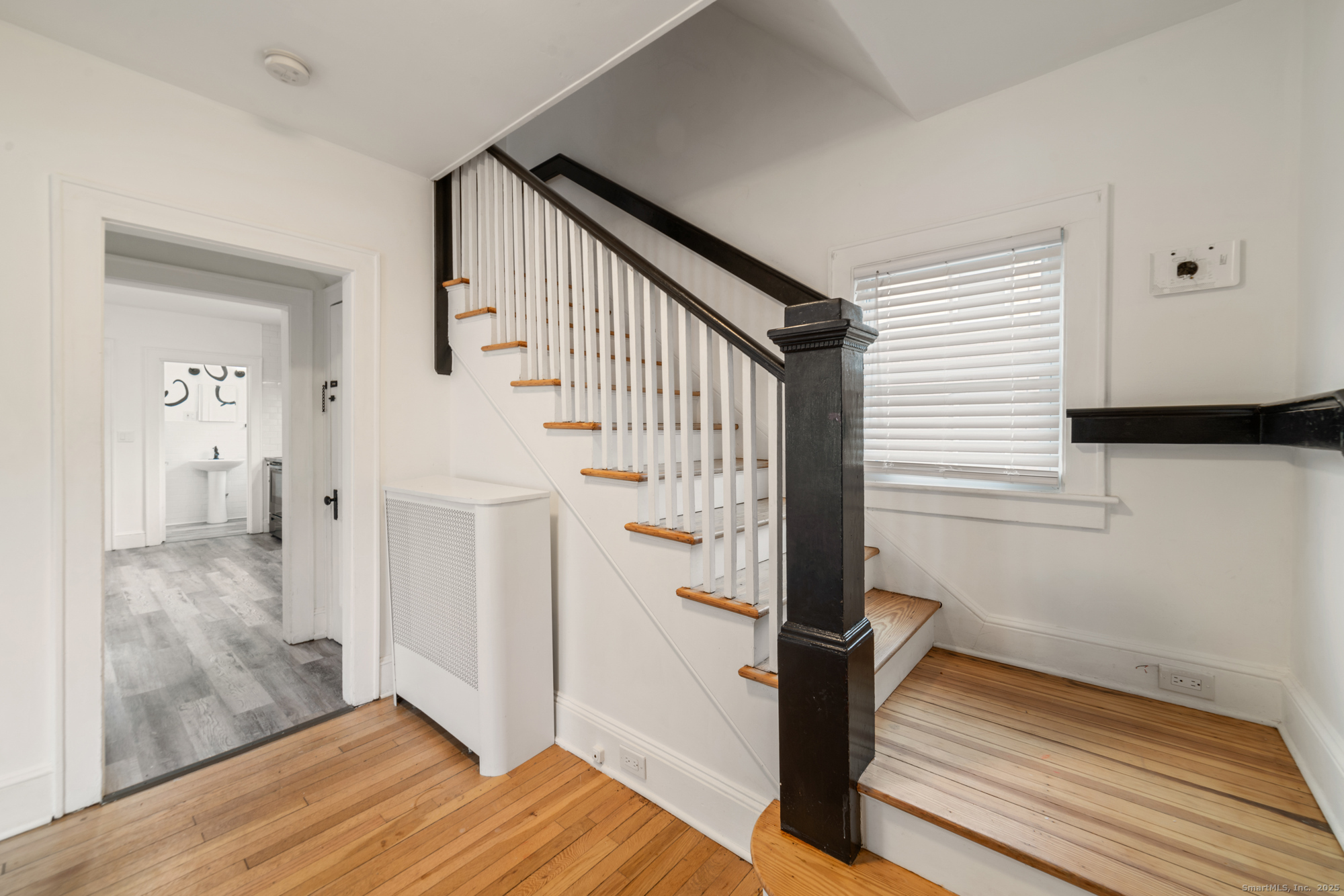 187 Ridge Road Middletown, CT 06457 - Photo 4 of 16 a view of a hallway with wooden floor and staircase