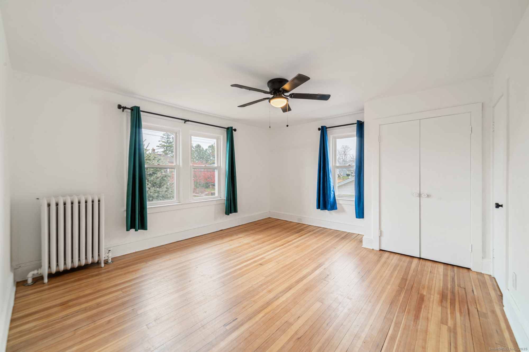 187 Ridge Road Middletown, CT 06457 - Photo 10 of 16 a view of an empty room with a window and wooden floor