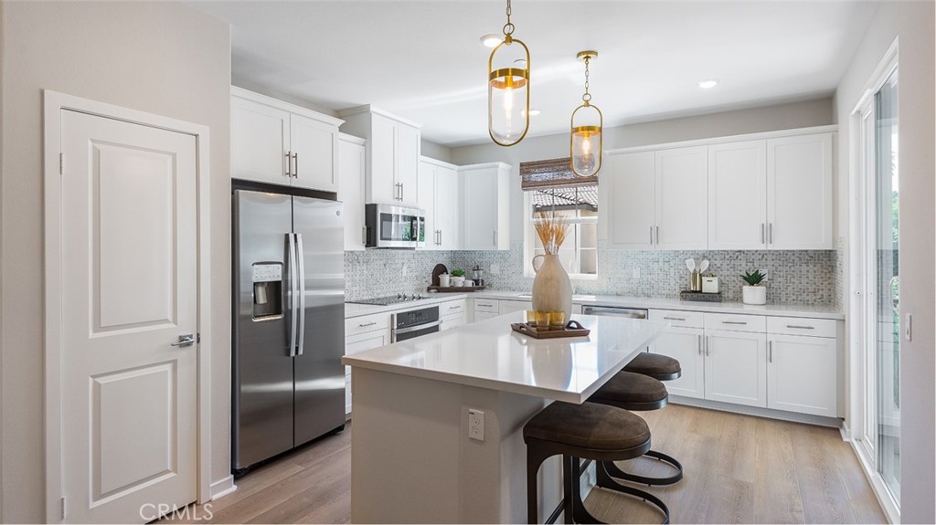 8397 Tapia Way Rancho Cucamonga, CA 91730 - Photo 3 of 22 a kitchen with refrigerator cabinets and a sink