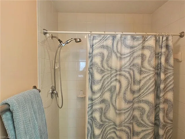 a bathroom with a shower curtain and a shower curtain