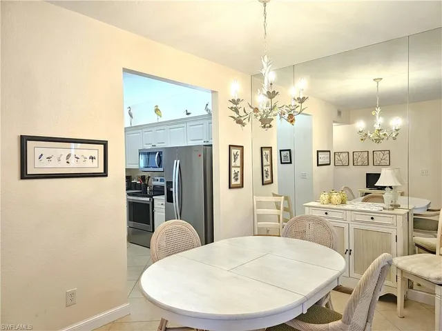 a view of a dining room with furniture and a chandelier