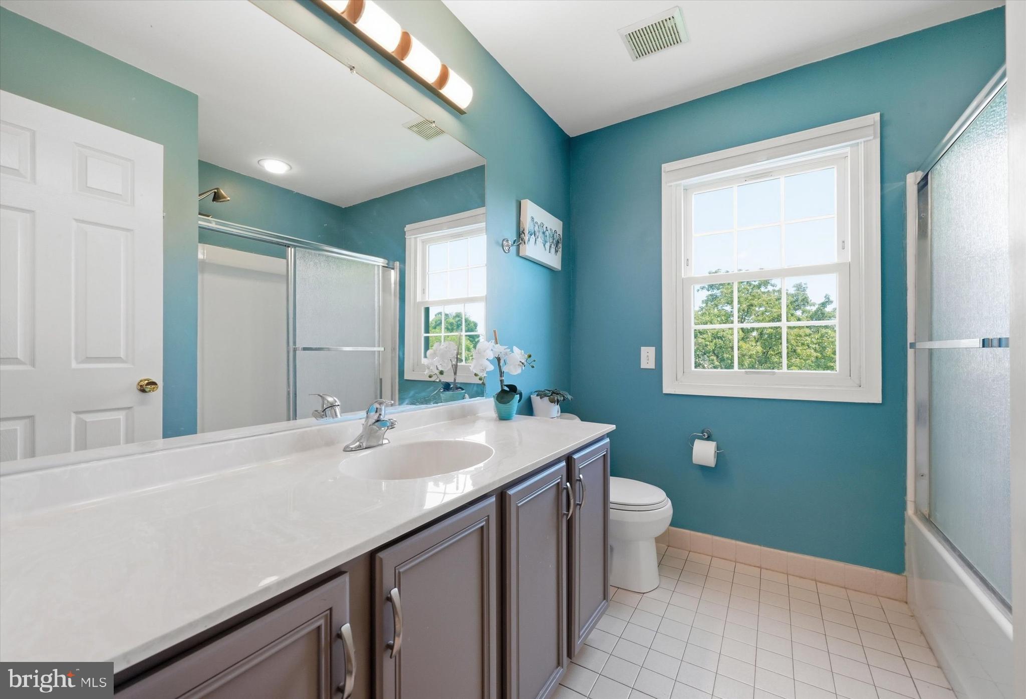 100 Cambridge Road Landenberg, PA 19350 - Photo 25 of 37 a bathroom with a sink a toilet a mirror and a window