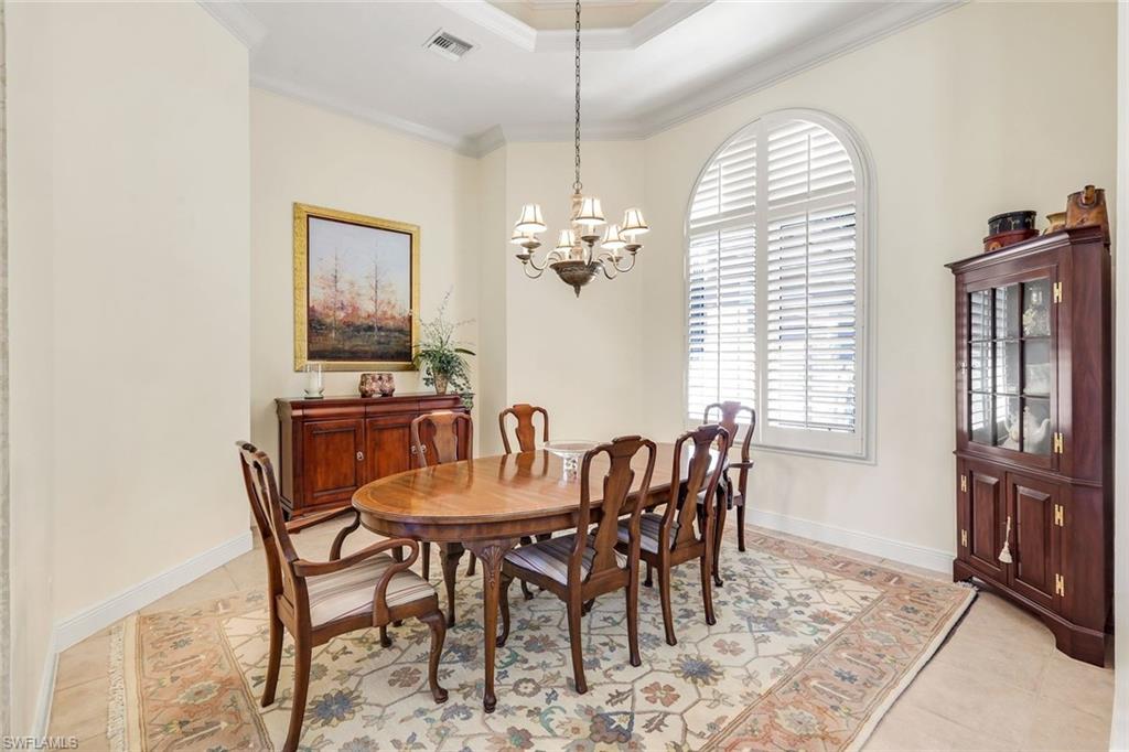 1468 Gormican Lane Naples, FL 34110 - Photo 11 of 36 a dining room with furniture a chandelier and window