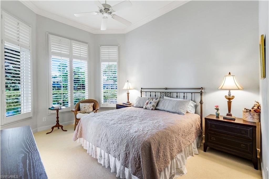 1468 Gormican Lane Naples, FL 34110 - Photo 23 of 36 a bed room with a bed and a chandelier