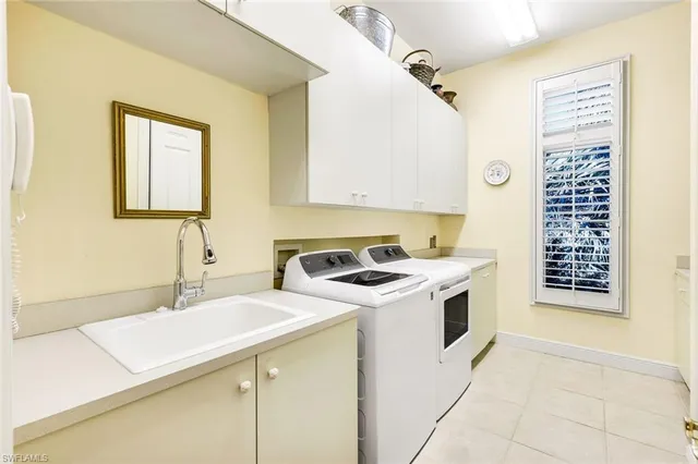 a view of a kitchen with sink washer and dryer