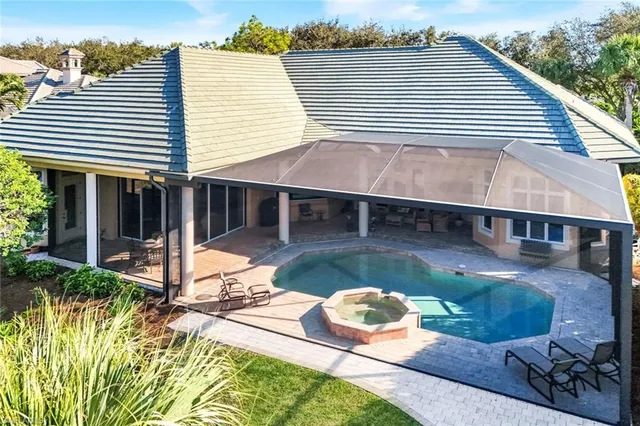 a view of a house with backyard and sitting area