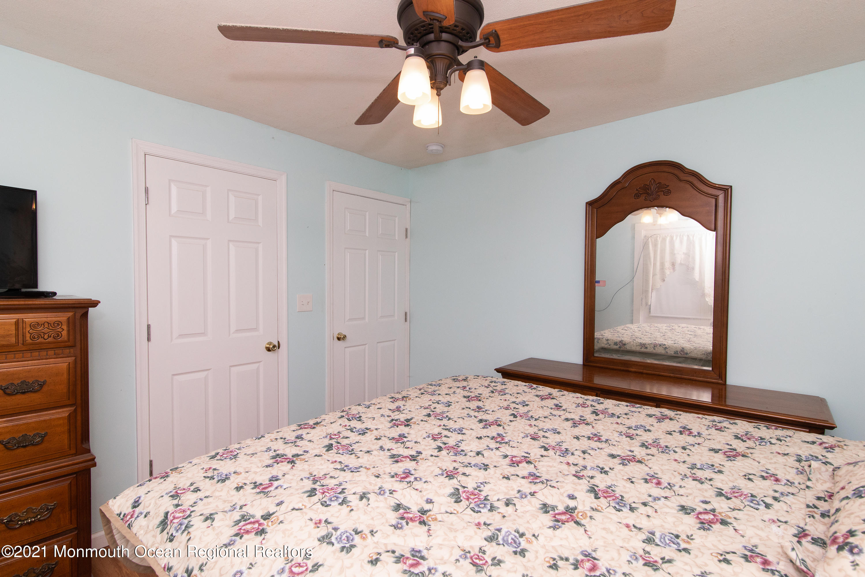 61 Cassville Road Jackson, NJ 08527 - Photo 13 of 26 a bedroom with a bed and a chandelier