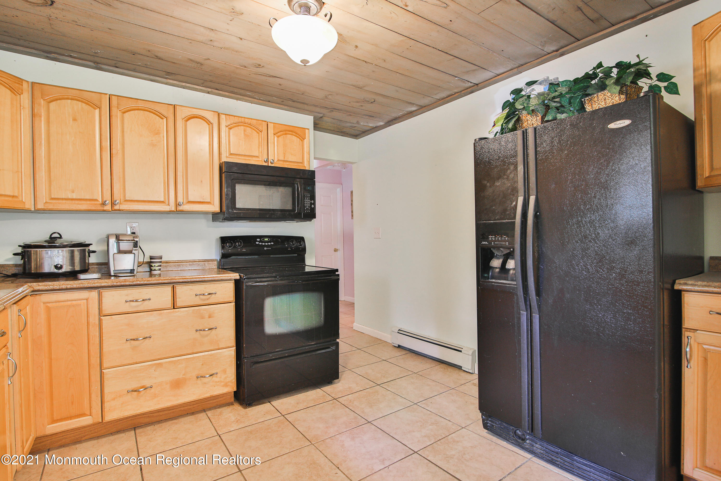 61 Cassville Road Jackson, NJ 08527 - Photo 5 of 26 a kitchen with granite countertop a refrigerator and a stove top oven