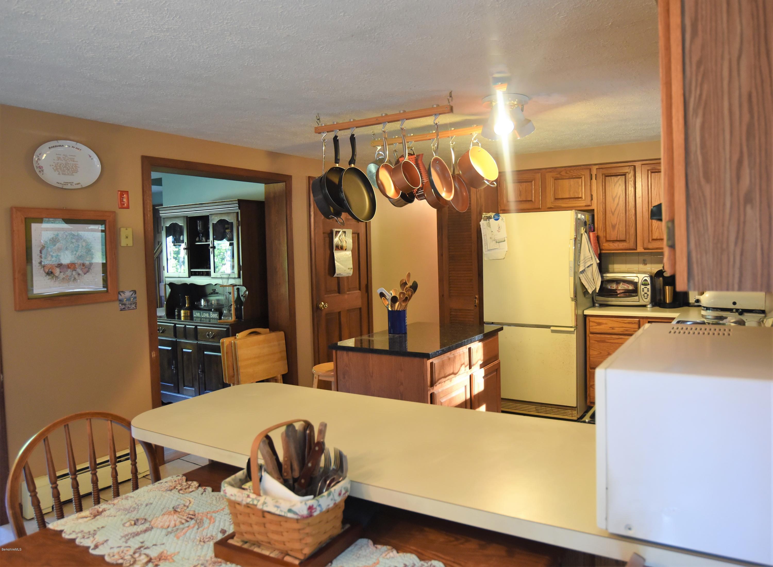 137 West Center Road Otis, MA 01253 - Photo 3 of 27 a living room with furniture a flat screen tv and a table