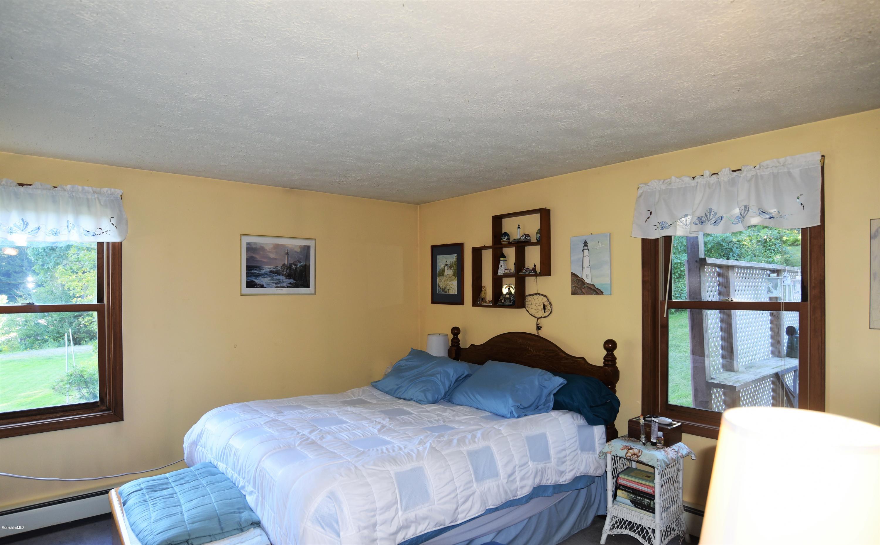 137 West Center Road Otis, MA 01253 - Photo 5 of 27 a bedroom with a bed and wooden floor