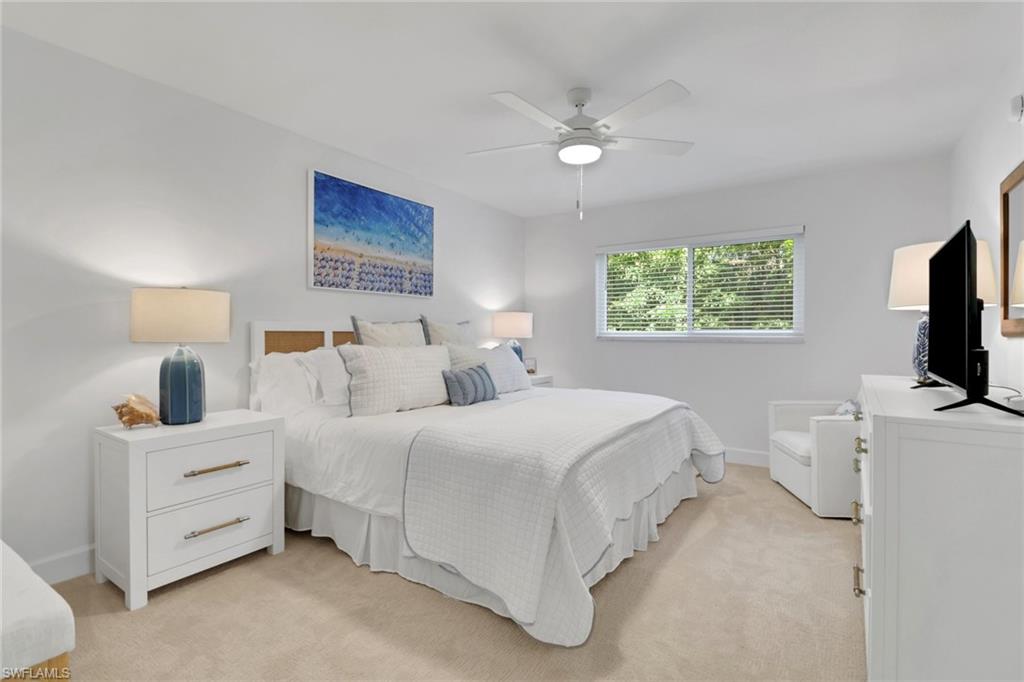 4160 Crayton Road, Unit A4 Naples, FL 34103 - Photo 12 of 23 a bedroom with bed tv and window
