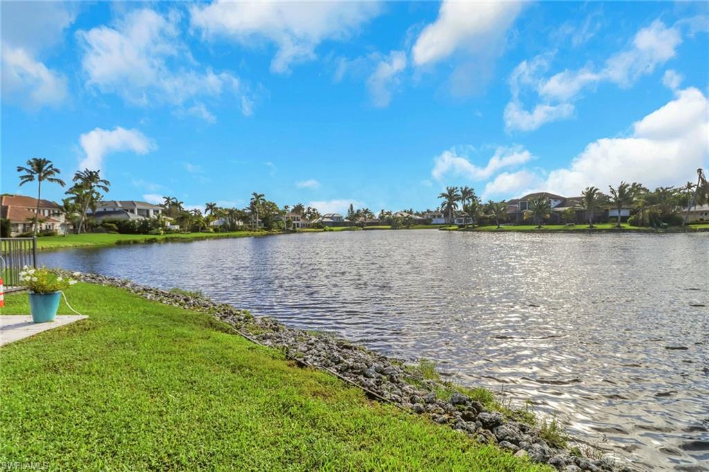 4160 Crayton Road, Unit A4 Naples, FL 34103 - Photo 17 of 23 a view of a lake with houses in the back