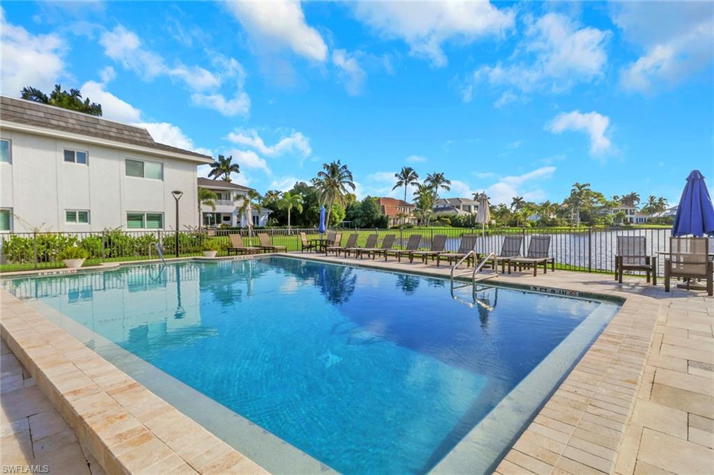 4160 Crayton Road, Unit A4 Naples, FL 34103 - Photo 18 of 23 a view of swimming pool with outdoor seating and lake view