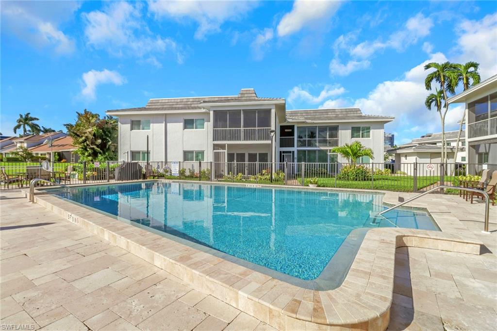 4160 Crayton Road, Unit A4 Naples, FL 34103 - Photo 19 of 23 a view of a house with a swimming pool
