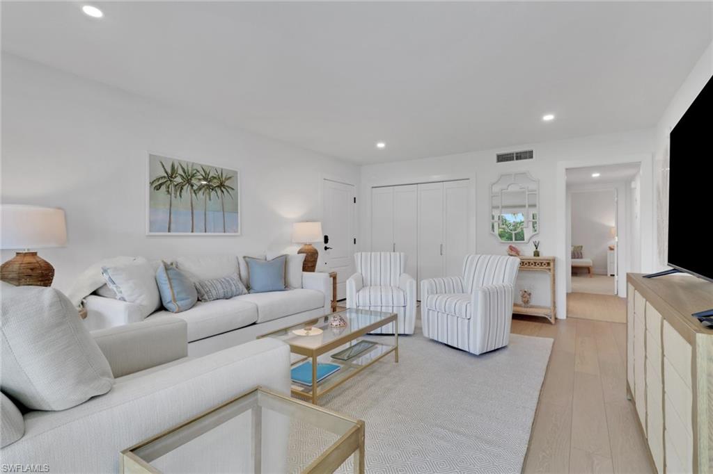 4160 Crayton Road, Unit A4 Naples, FL 34103 - Photo 2 of 23 a living room with furniture and a large window