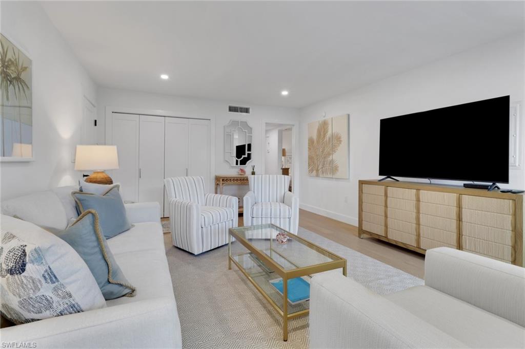 4160 Crayton Road, Unit A4 Naples, FL 34103 - Photo 3 of 23 a living room with furniture and a flat screen tv