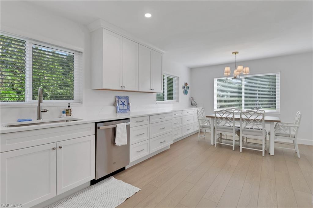 4160 Crayton Road, Unit A4 Naples, FL 34103 - Photo 8 of 23 a kitchen with cabinets table and chairs