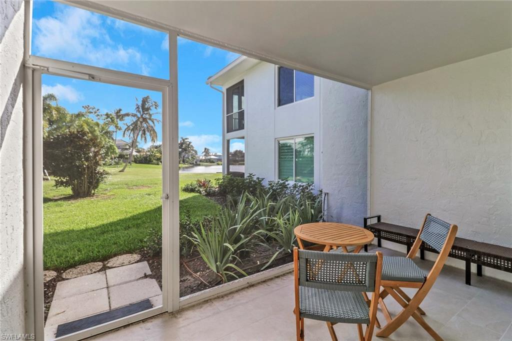 4160 Crayton Road, Unit A4 Naples, FL 34103 - Photo 10 of 23 a view of a porch with chairs and backyard