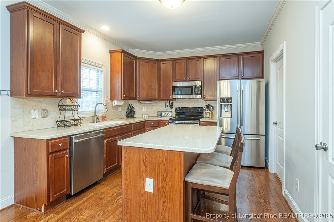 198 Grouse Run Raeford, NC 28376 - Photo 18 of 38 a kitchen with stainless steel appliances granite countertop a refrigerator sink and cabinets