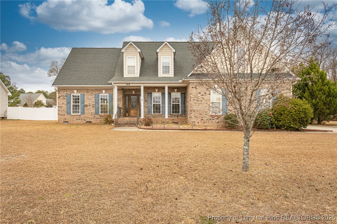 198 Grouse Run Raeford, NC 28376 - Photo 2 of 38 front view of a building with a yard