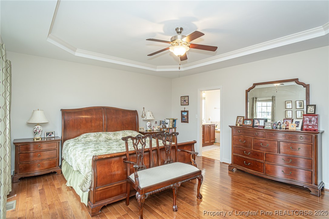 198 Grouse Run Raeford, NC 28376 - Photo 23 of 38 a bedroom with a bed and wooden floor