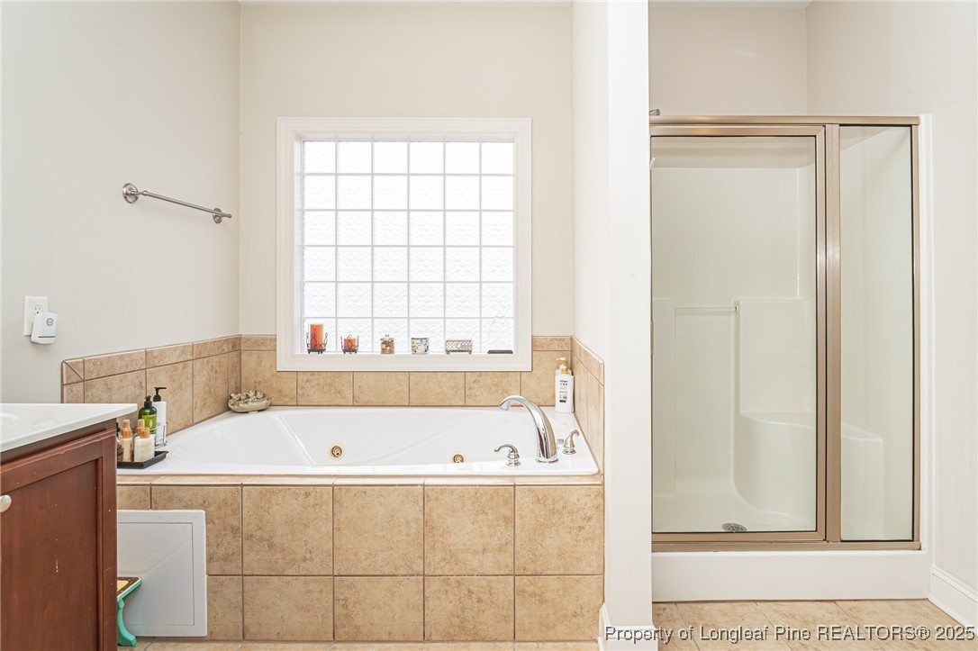 198 Grouse Run Raeford, NC 28376 - Photo 30 of 38 a bathroom with a bathtub and a window