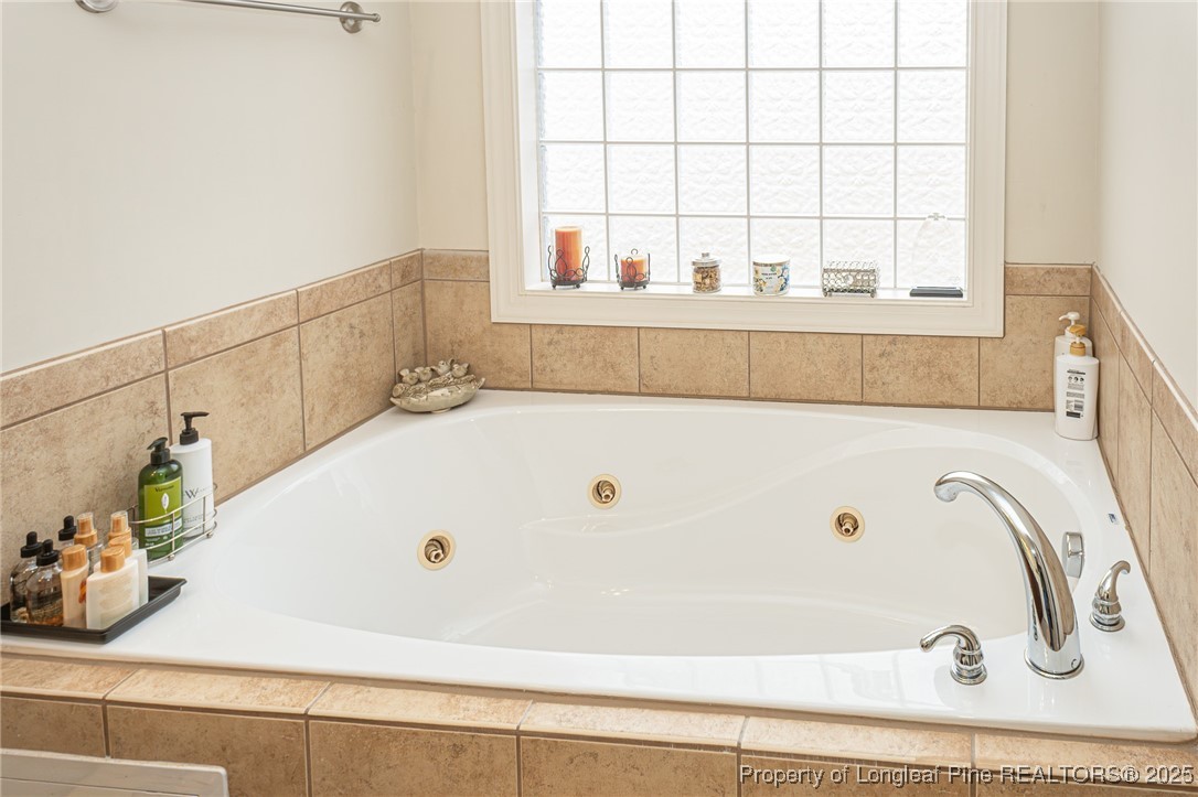 198 Grouse Run Raeford, NC 28376 - Photo 32 of 38 a bathroom with a tub and a window